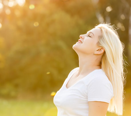 Free Happy Woman Enjoying Nature. Beauty Girl Outdoor. Freedom concept. Beauty Girl over Sky and Sun. Sunbeams. Enjoyment